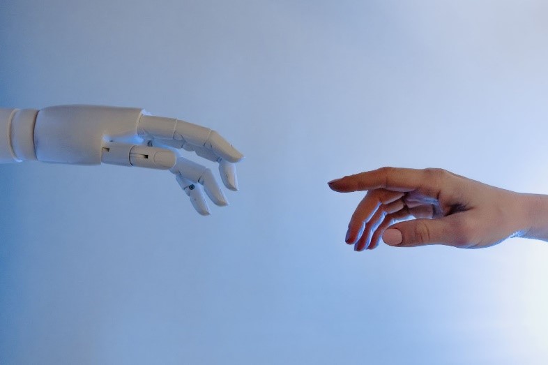 A Robotics hand touching human hand